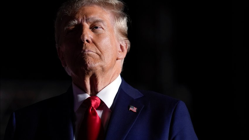 Republican presidential nominee former President Donald Trump listens to opera singer Christopher Macchio after speaking at a campaign rally at the Butler Farm Show, Saturday, Oct. 5, 2024, in Butler, Pa.