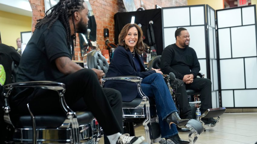 Democratic presidential nominee Vice President Kamala Harris, center, sits in conversation with Black men at Philly Cuts barbershop during a campaign stop, Sunday, Oct. 27, 2024, in Philadelphia. (AP Photo/Susan Walsh)