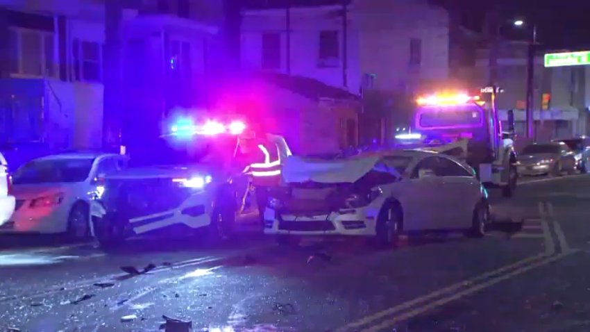 Vehicles remain on Castor Avenue after, police said, a driver sought in connection to a murder in Maryland led police on a chase that ended in a crash in North Philadelphia late Sunday.