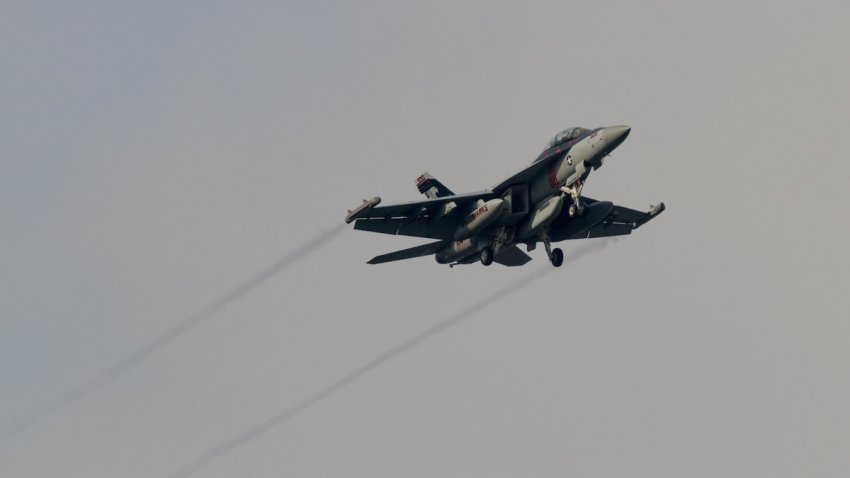 A Boeing EA-18G Growler jet fighter with the VAQ-141, US Navy Electronic Attack Squadron known as the Shadow hawk flies low over Chuo Rinkan in Kanagawa, Japan.