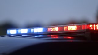 Closeup of LED police car light bar flashing red and blue during National Night Out on August 1, 2023 at Switchyard Park in Bloomington, Indiana.