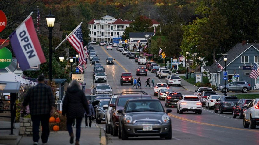 DOOR COUNTY, WI – October 11:
People walk through Sister Bay in Door County, Wisconsin on October 11, 2023. The swing county, in the battleground state of Wisconsin, has backed every presidential election’s winning candidate since 2000. However, the county’s residents on both sides of the political aisle are tiring of politics altogether as the next election looms. (Photo by Carolyn Van Houten/The Washington Post via Getty Images)