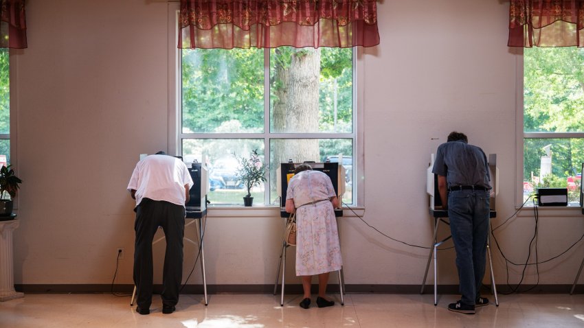 Voters cast their ballots at a voting precinct