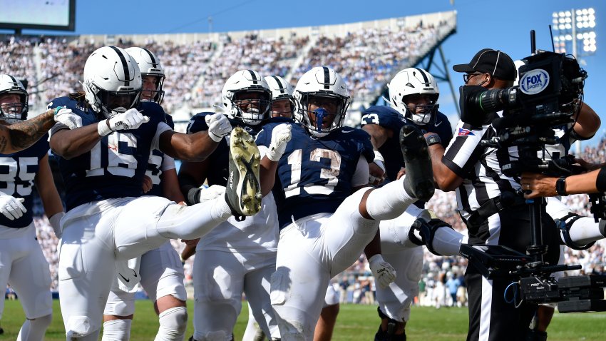 Penn State running back Kaytron Allen does a kick celebration with offensive teammates