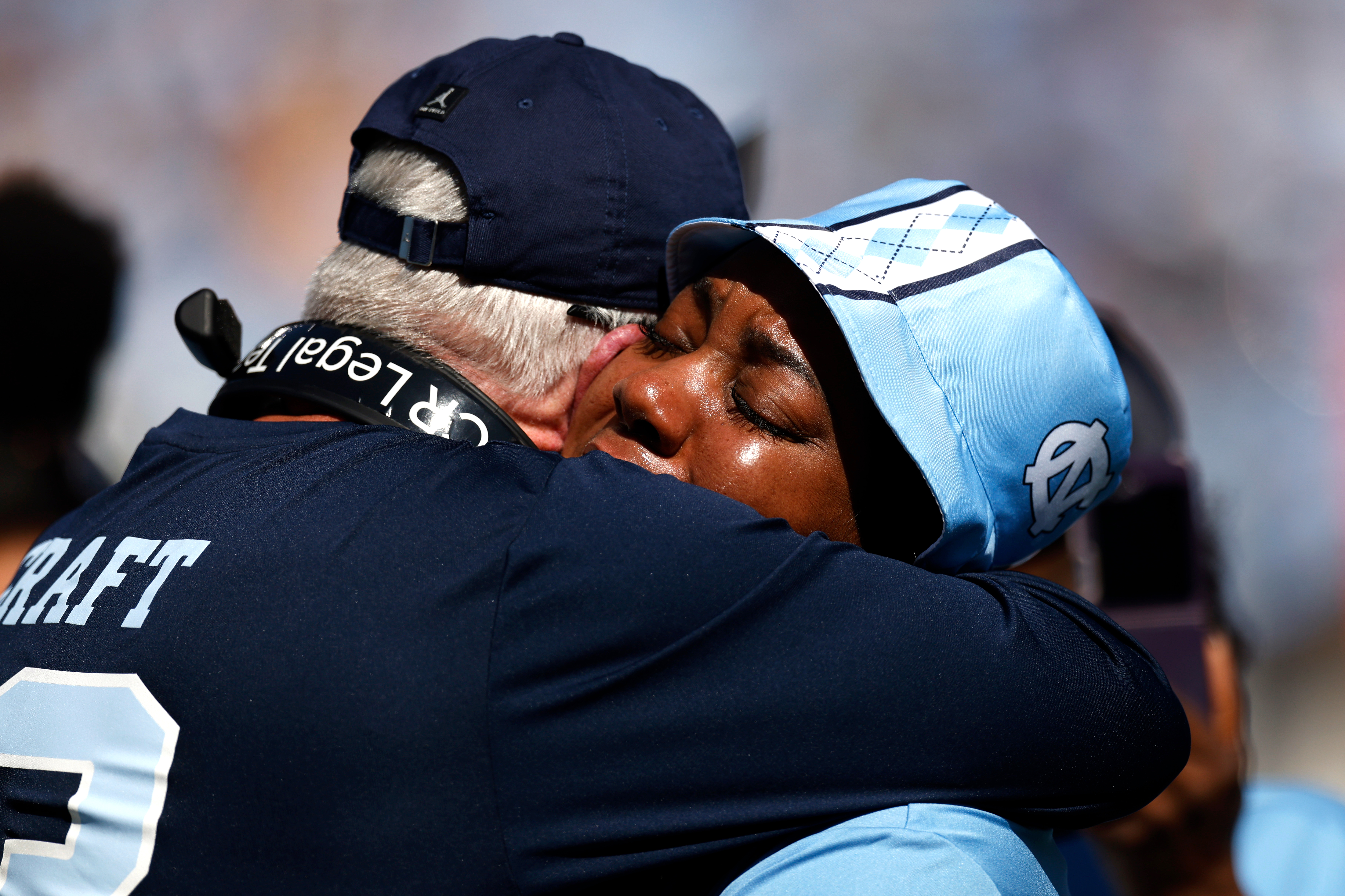 Head coach Mack Brown (L) of the North Carolina Tar Heels embraces September Craft