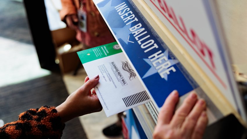 A person drops off a mail-in ballot on October 15, 2024 in Doylestown, Pennsylvania.