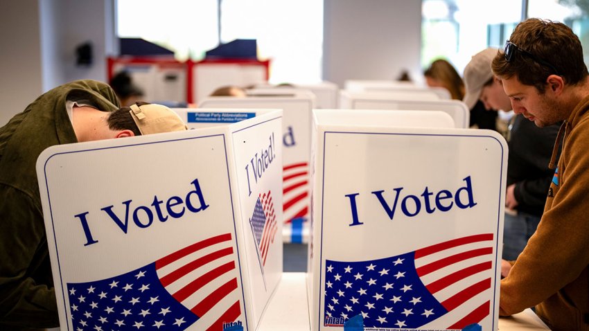 Voters mark their ballots during early voting at a polling location at the Ellen M. Bozeman Government Center in Arlington, Virginia, on Saturday, Oct. 26, 2024.