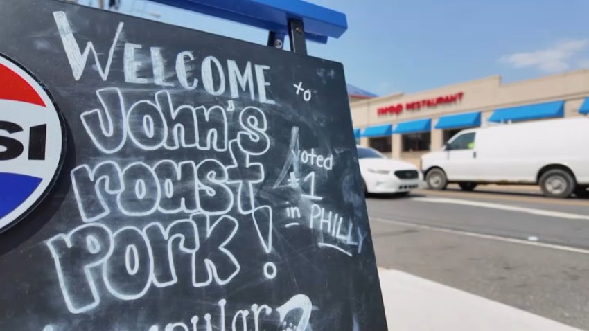 John's Roast Pork welcome sign on chalkboard