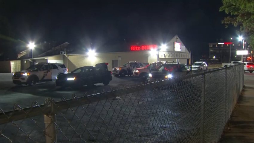 Police vehicles surround sedan