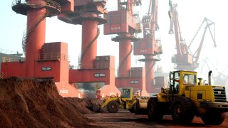 Workers transporting soil containing rare earth elements for export at a port in Lianyungang, Jiangsu province, China, Oct. 31, 2010.