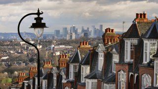 Period red-brick home rooftops in a suburb overlooking London’s financial district. 