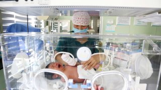 A medical worker is taking care of newborns at Dongfang Hospital in Lianyungang, China, on January 1, 2024.