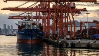 Containers near a berthed cargo vessel at a terminal in the southeastern port city of Busan on Nov. 24, 2024.