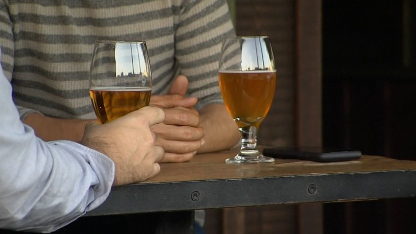 People drinking beer at a restaurant.