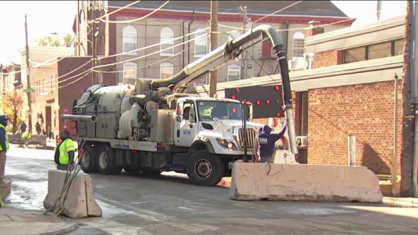 Crews work along Girard Avenue in Philadelphia's Northern Liberties section on Monday, Nov. 25, 2024, after a water main break caused damage and shut the roadway.