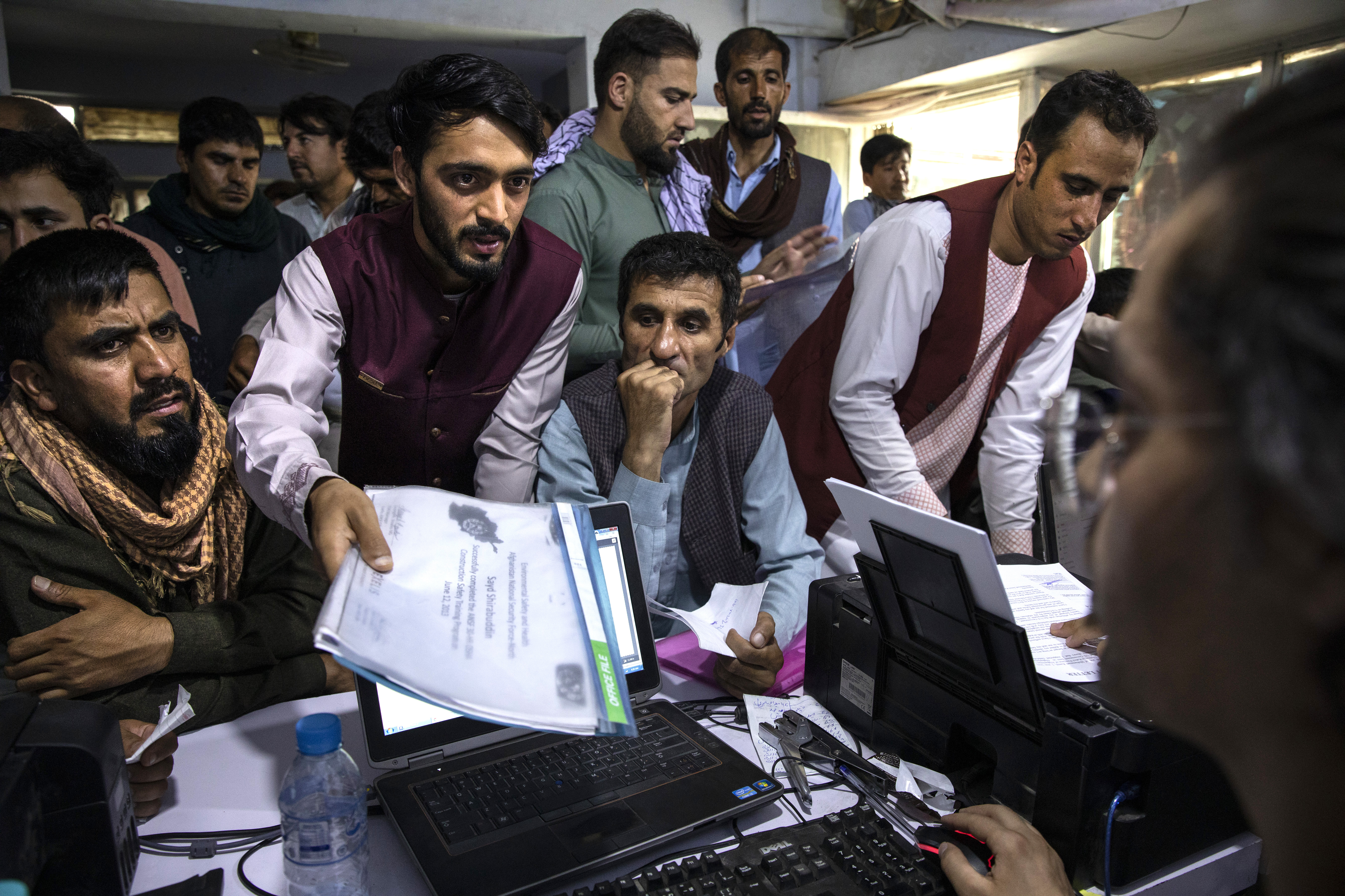 Afghan applicants crowd into a cafe