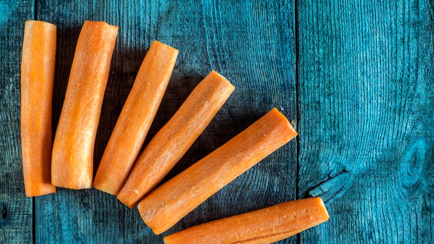 peeled carrot on weathering  wooden background