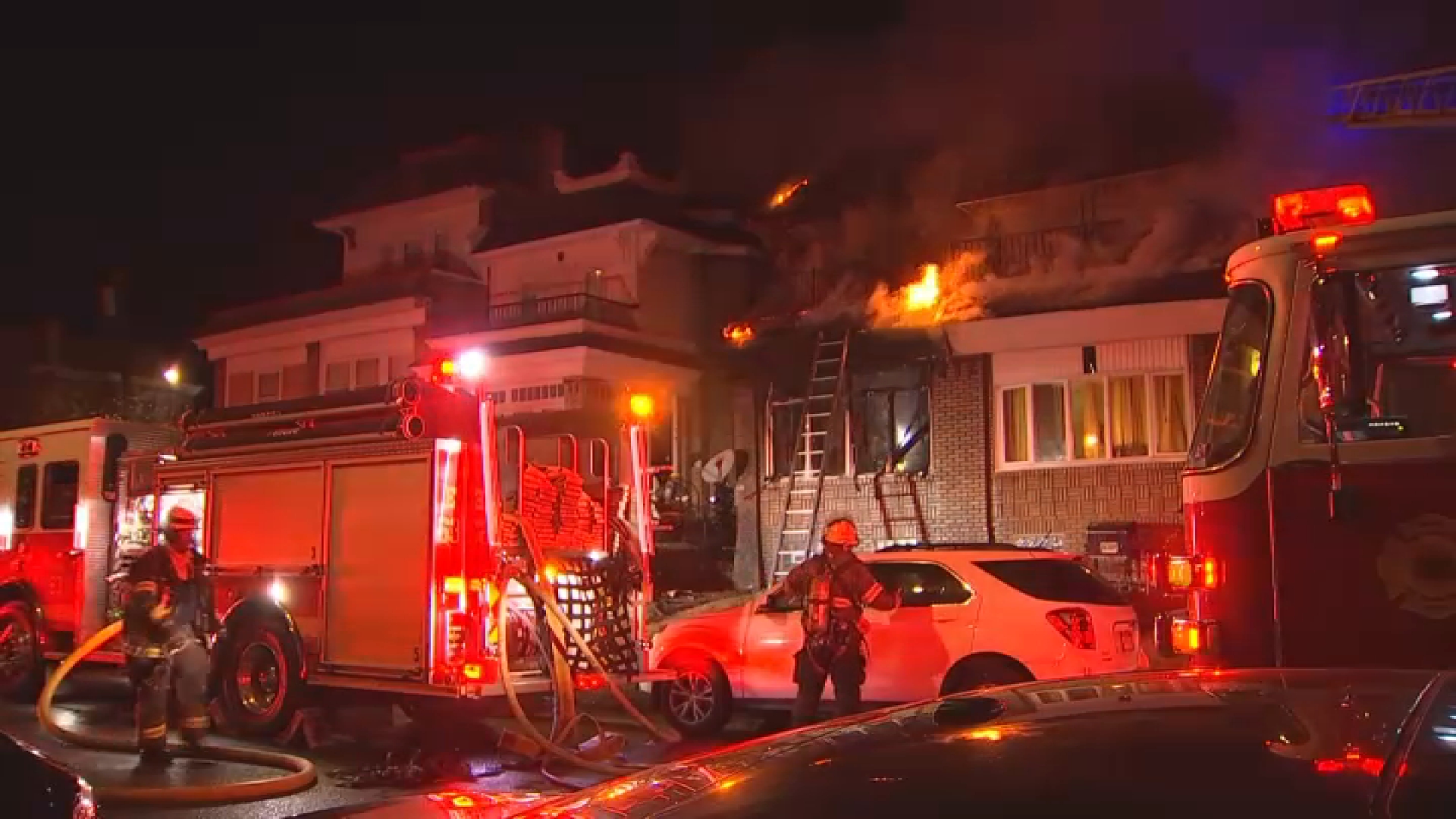 Fire crews work to extinguish a fire in a rowhome along 68th Street in Philadelphia's West Oak Lane neighborhood on Sunday, Nov. 17, 2024.