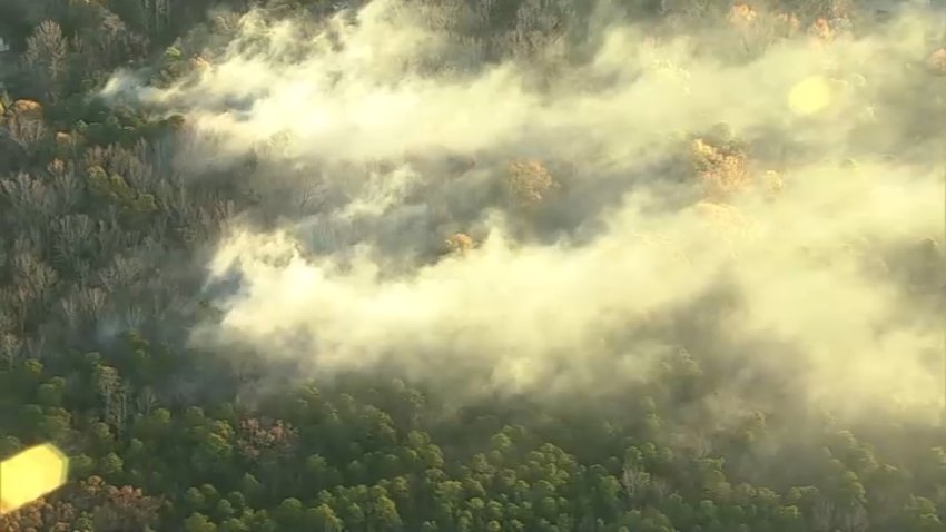 Smoke rises from wooded area of Medford