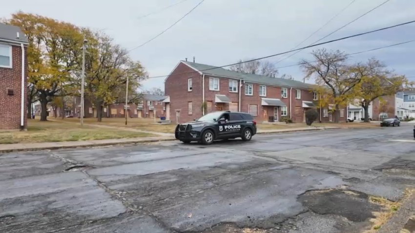 Black police car parked outside of homes