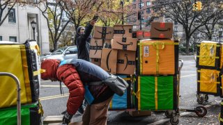 Amazon workers deliver packages on Cyber Monday in New York, US, on Monday, Nov. 27, 2023. 