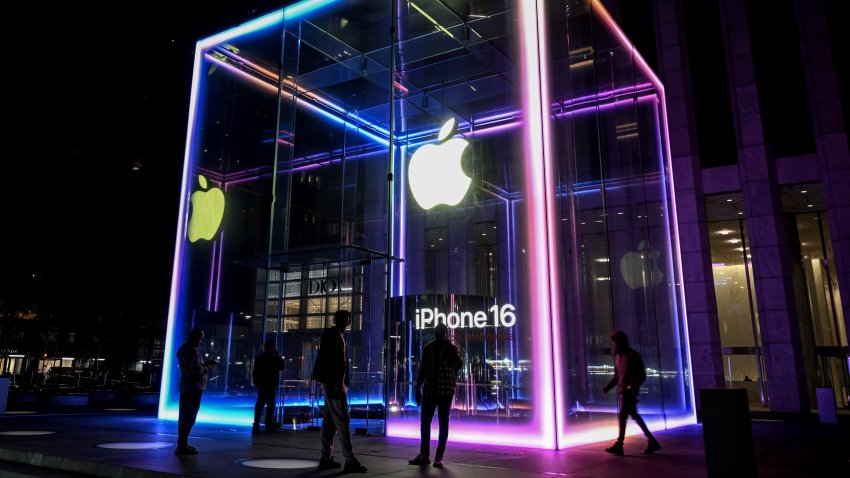 Apple’s iconic Fifth Avenue store is illuminated with iOS 18 colors as the new iPhone 16 series sale kicks off, in New York on Sept. 20, 2024.