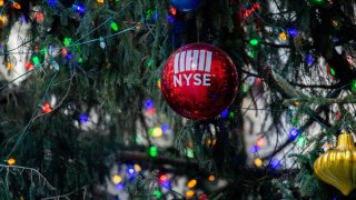 A Christmas tree, with NYSE branded ornaments, stands in front of The New York Stock Exchange on December 20, 2021 in New York City.