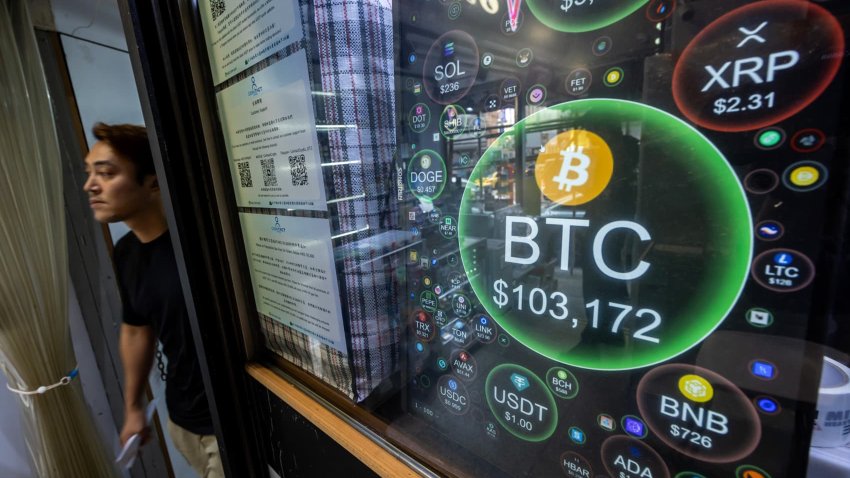 The price of Bitcoin against the US dollars, reaching over $100,000, on a screen at a cryptocurrency exchange store in Hong Kong, China, on Thursday, Dec. 5, 2024. 