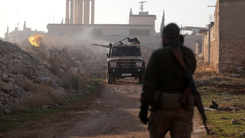 TOPSHOT – Fighters fire towards Syrian Army troops in the Rashidin district on the outskirts of Aleppo on Nov. 29, 2024.