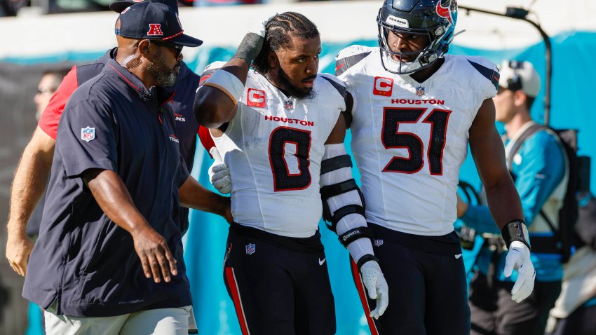 Houston Texans linebacker Azeez Al-Shaair (0) is escorted off the field