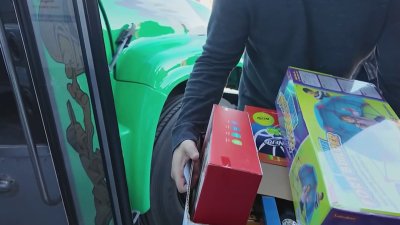 Eagles fans cheer on the Birds while giving toys to kids at St. Christopher's Hospital