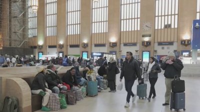 Holiday travelers boarding trains at Philadelphia's 30th Street Station