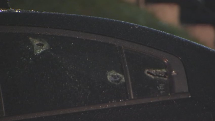 Bullet holes in car window.