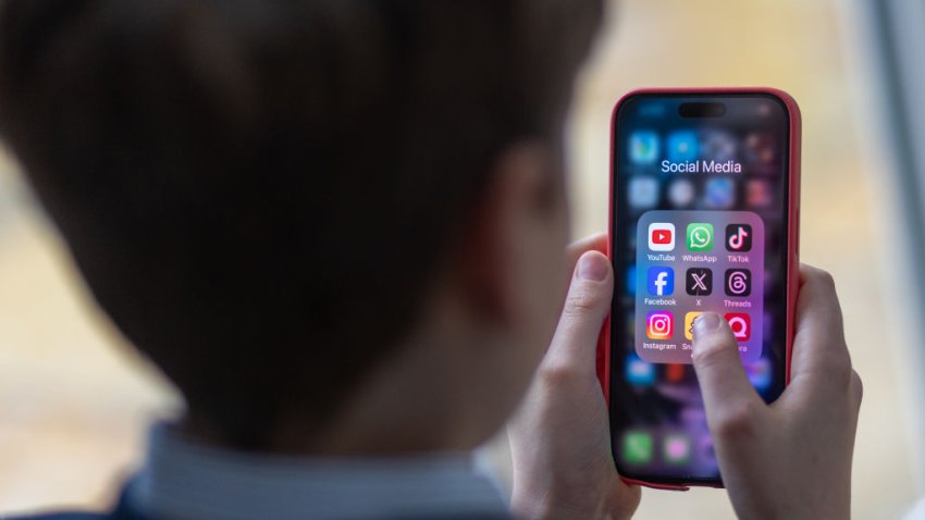 In this photo illustration a a 12-year-old school boy looks at a iPhone screen A 12-year-old boy looks at an iPhone screen showing various social media apps including TikTok, Facebook and X on February 25, 2024 in Bath, England.