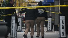 Police cover evidence with paper cups as as CEO of UnitedHealthcare Brian Thompson, 50, was shot as he entered the New York Hilton after 6:45am on December 4, 2024 in New York. The chief executive of one of the United States's largest health insurance companies, UnitedHealthcare, was shot and killed outside a New York Hilton hotel in an apparently targeted hit Wednesday, US media reported. (Photo by Bryan R. SMITH / AFP) (Photo by BRYAN R. SMITH/AFP via Getty Images)