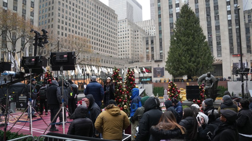 People gather near the stage ahead of tonight’s 2024 Rockefeller Center tree lighting ceremony in New York on December 4, 2024. (Photo by Bryan R. SMITH / AFP) (Photo by BRYAN R. SMITH/AFP via Getty Images)