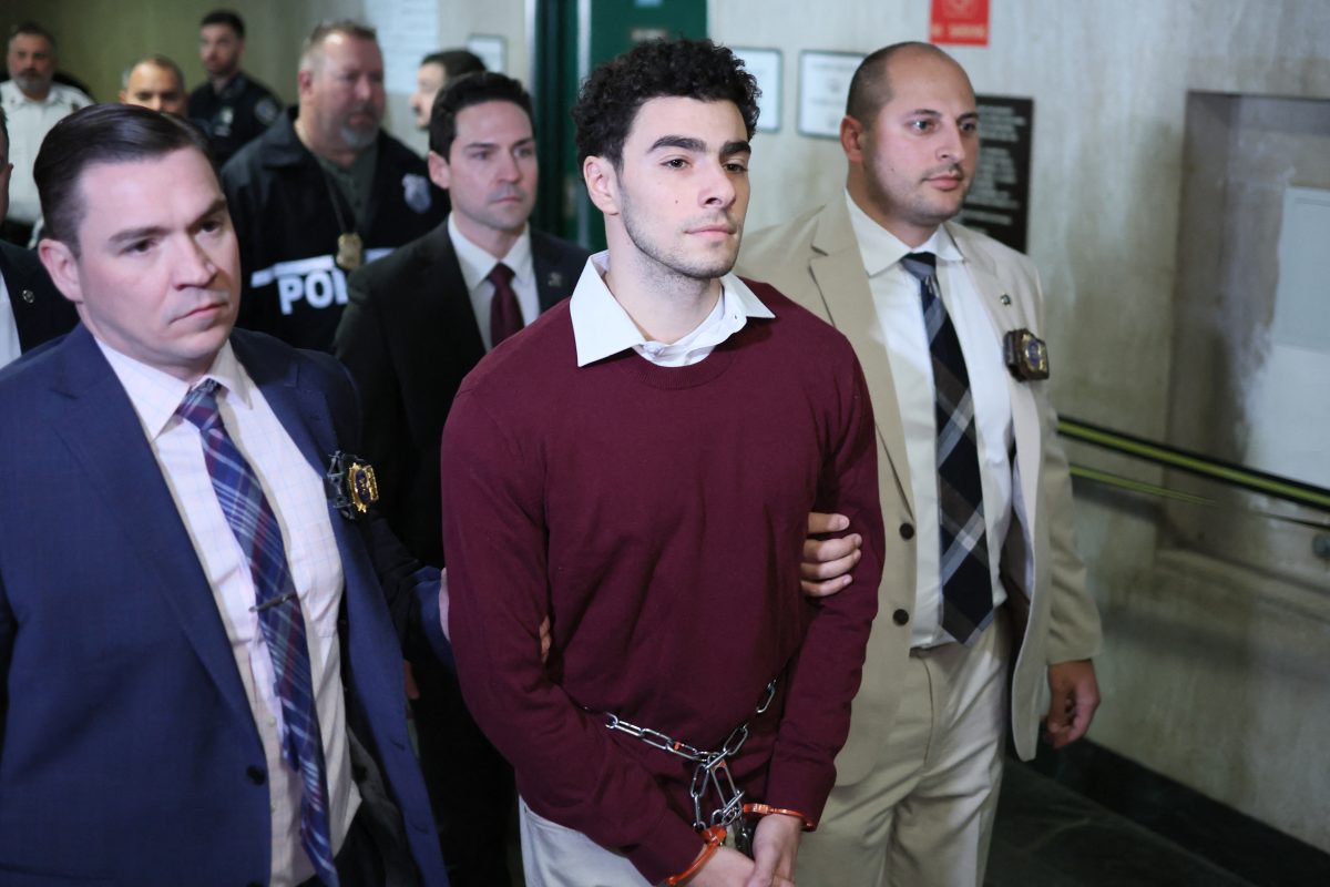 Luigi Nicholas Mangione (C) arrives at Manhattan Criminal Court in New York on December 23, 2024. Mangione, 26, is accused of shooting UnitedHealthcare chief executive Brian Thompson on a Manhattan street on December 4. (Photo by CHARLY TRIBALLEAU / AFP) (Photo by CHARLY TRIBALLEAU/AFP via Getty Images)