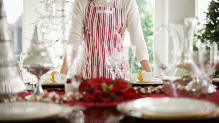 Woman Standing by Table Decorated for Christmas