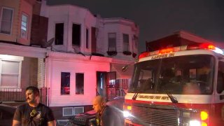 Fire crews respond to a house fire in Philadelphia's Kingsessing neighborhood, late Tuesday evening, that injured three people.