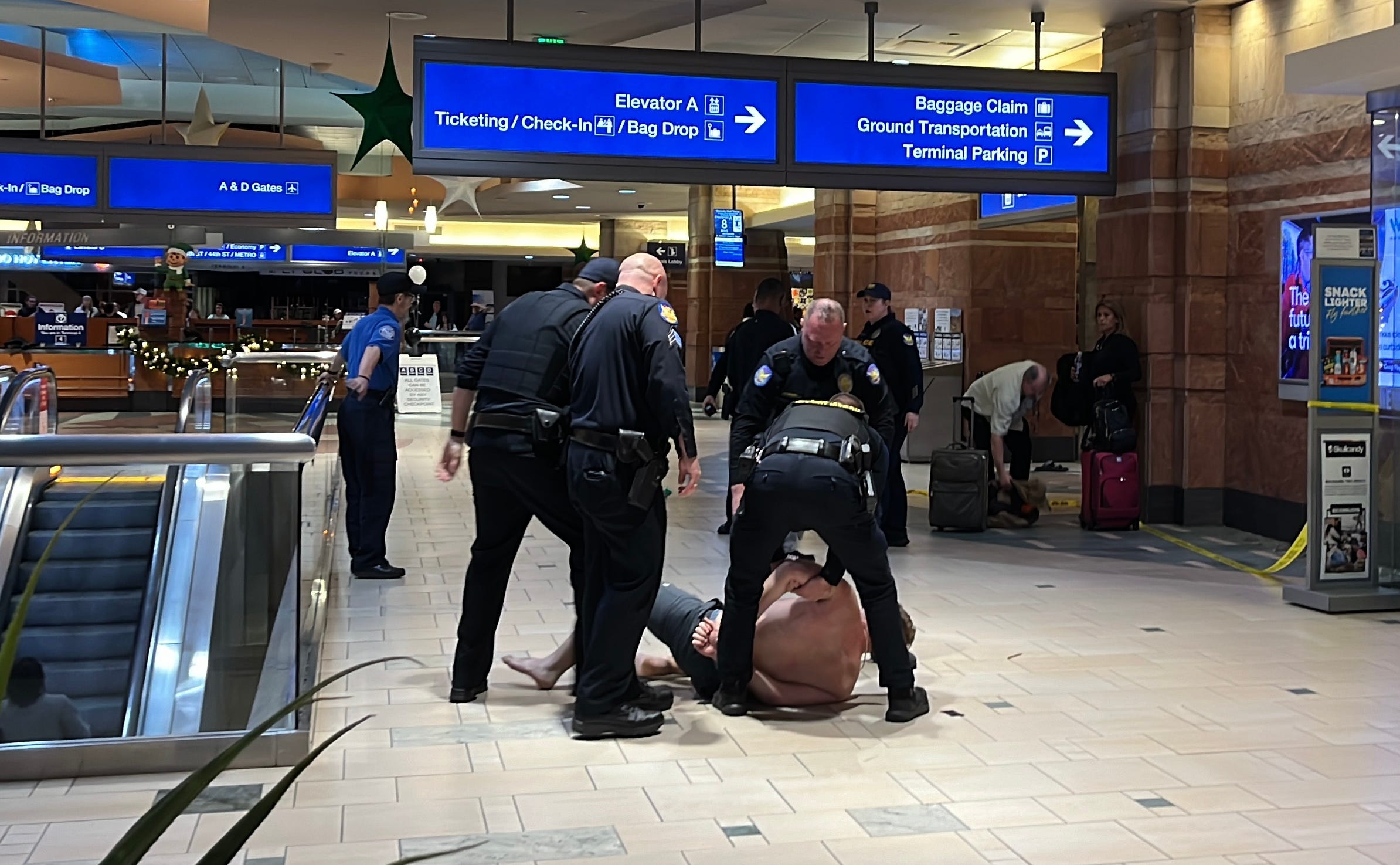 Phoenix police arrest a man on Dec. 25, 2024, who police said arrived at Sky Harbor with guns after he received a text falsely reporting an active shooter at the airport. An unrelated shooting did occur at the airport earlier that night, leaving four people hurt.