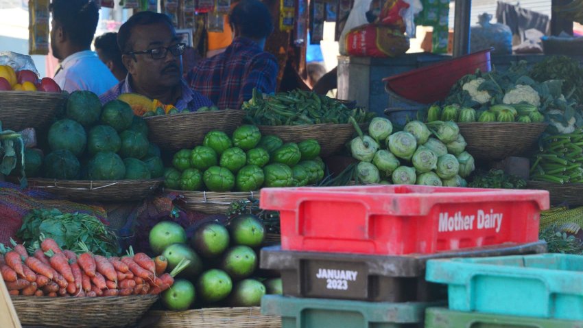 People buy vegetables at a vegetable market in Siliguri, India, on December 28, 2024.