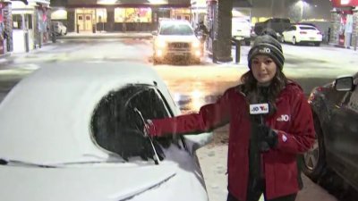 A reporter whoops as snow covers cars in NJ