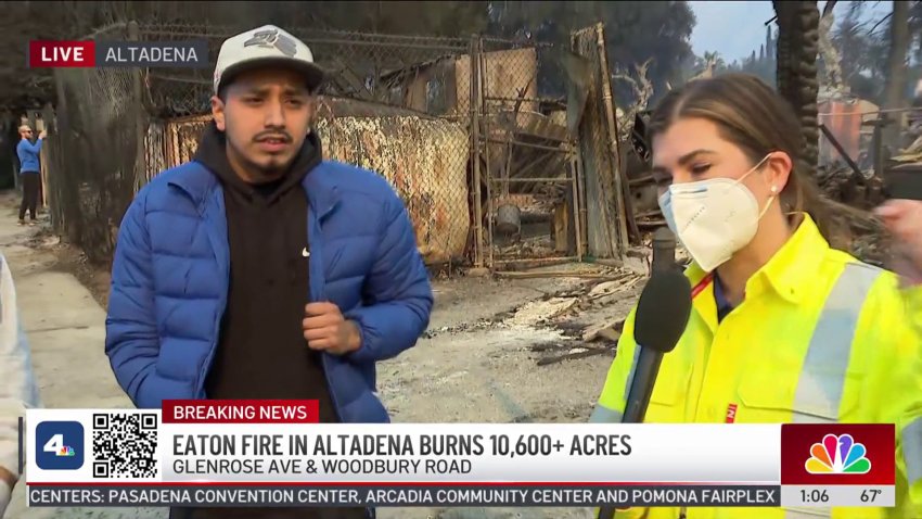 A man outside a burned home with reporter