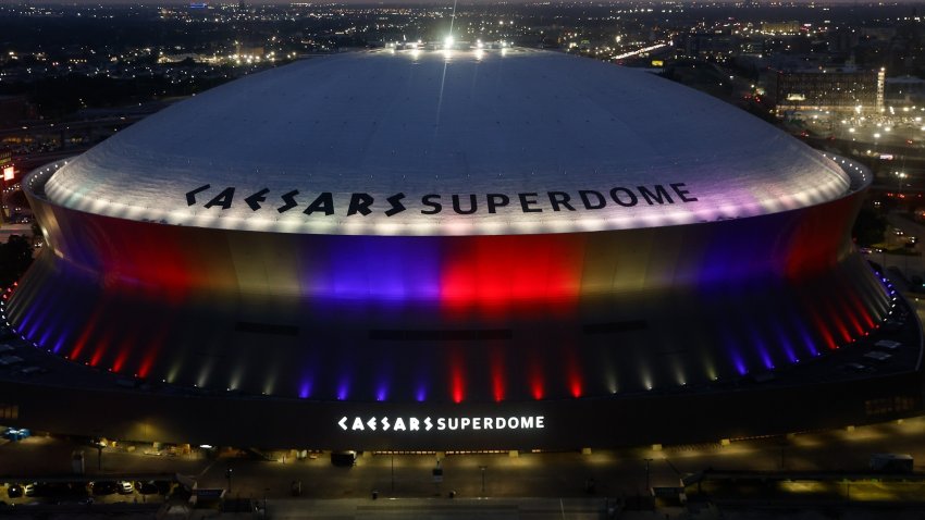 Exterior of Caesars Superdome at night.