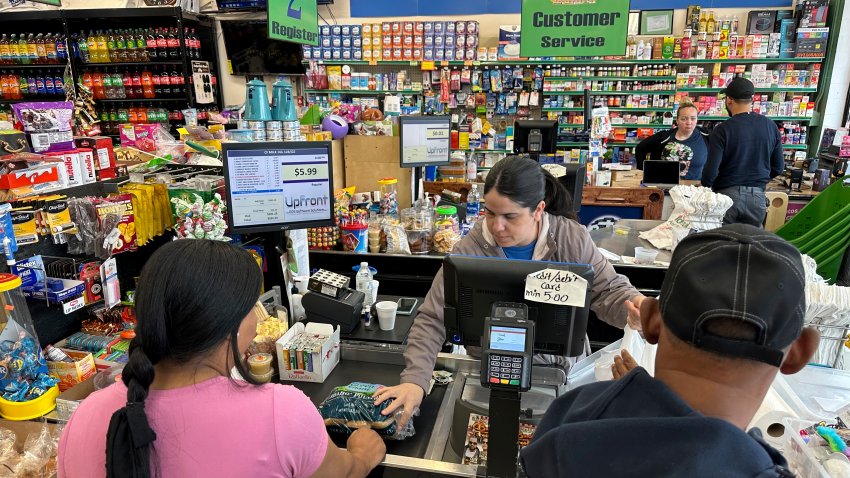 Cashier Rosa Dilone serves customers at Mi Tierra Supermarket in Hazleton, Pa., on Thursday, May 16, 2024.