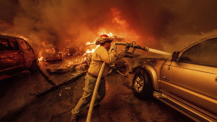 A firefighter battles the Eaton Fire