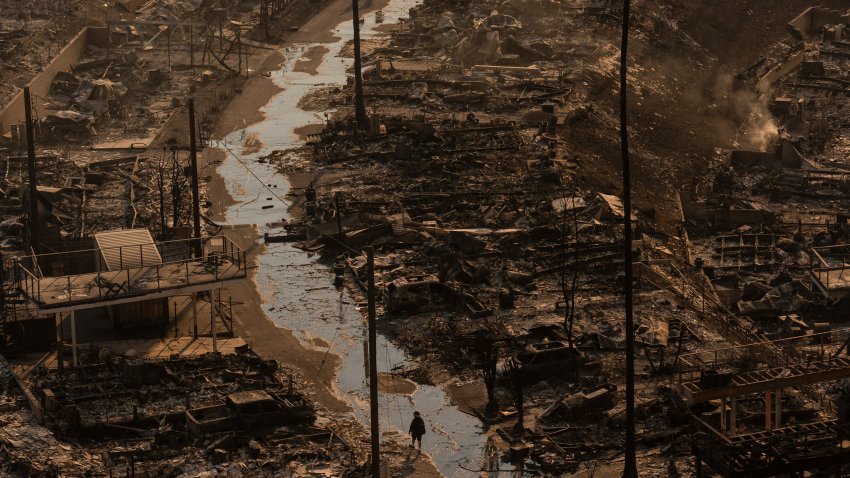 A person walks amid the destruction