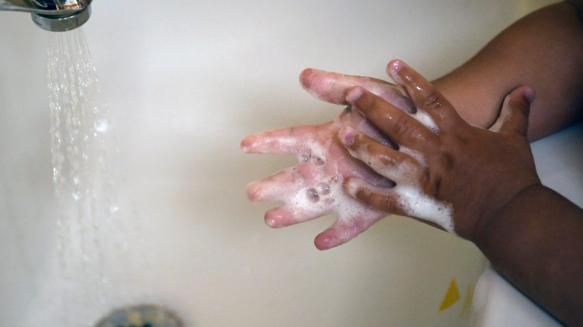 A child washes her hands