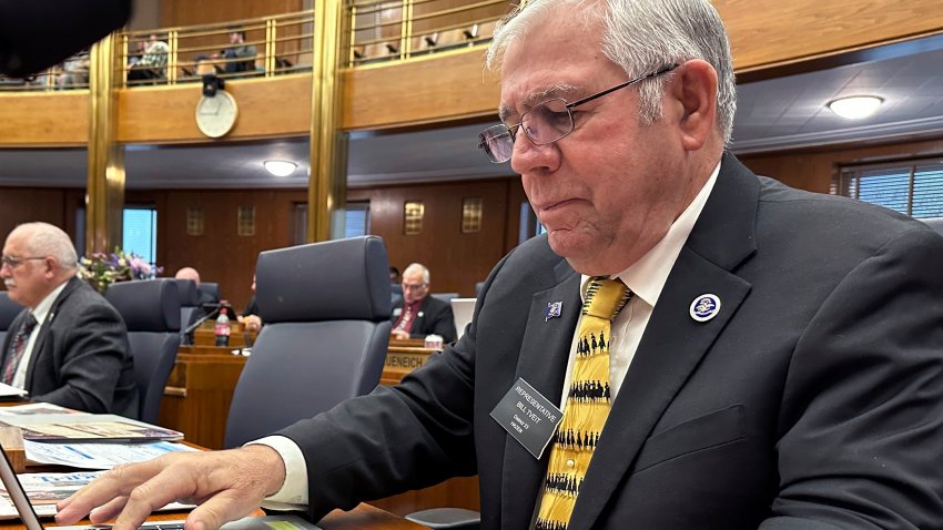 North Dakota Republican state Rep. Bill Tveit works at his desk on Wednesday, Jan. 22, 2025, in the House of Representatives at the state Capitol in Bismarck, N.D.