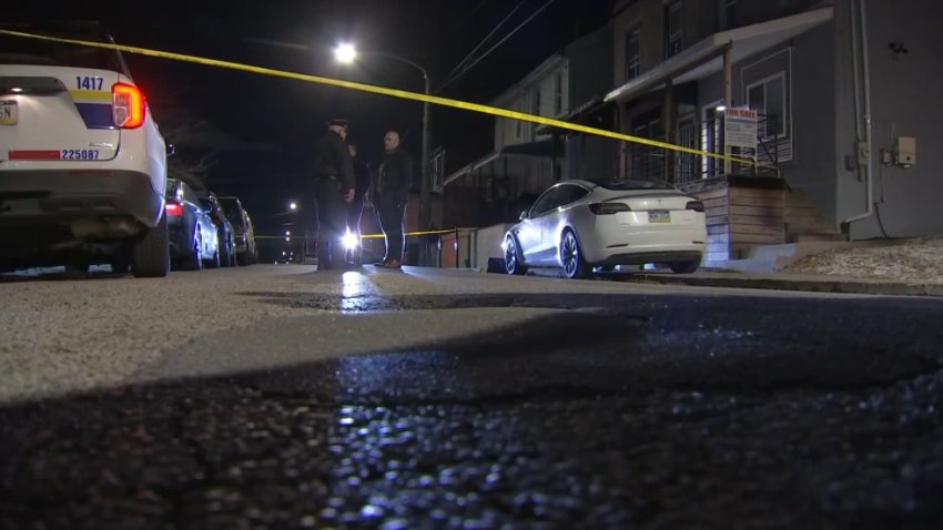 Police officials stand in the street after, investigators said, a man was shot by his father during an incident in Philly's East Mount Airy neighborhood on Saturday, Jan. 4, 2025.